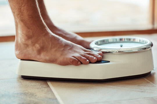 Scale, fitness and feet in bathroom with weight loss results, progress or health and wellness at home. Person with foot on measuring machine for training, exercise or body goals and check on floor