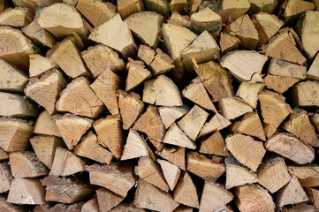 Pile of chopped firewood prepared for winter. Firewood background.