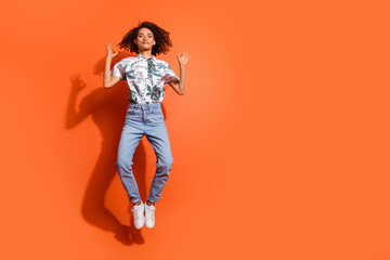 Full body length photo of woman in jeans and summer stylish shirt jumping air with good vibes okey...