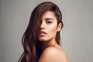 Naklejka premium Aesthetic, hair and portrait of natural woman in studio on gray background for keratin or shampoo treatment. Beauty, cosmetics and wellness with confident model at salon for conditioning or haircare