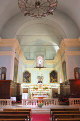 Nave of the church of Ste Marie de l'Assomption in Sartène in Corsica (Isle of Beauty). Note the superb baroque style high altar, in polychrome marble exported in the 17th C from Liguria and Tuscany