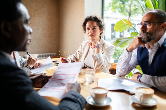 Business meeting in a cafe with diverse professionals