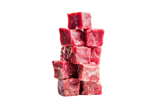 Raw beef meat cubes scattered across a white surface, like dice on a game board, isolated on white background