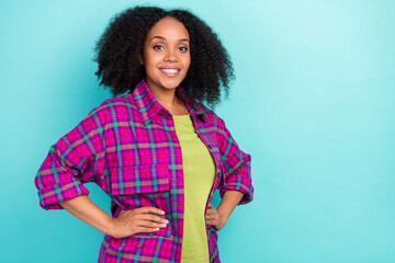 Photo of pretty young woman hands waist posing wear checkered shirt isolated on teal color...