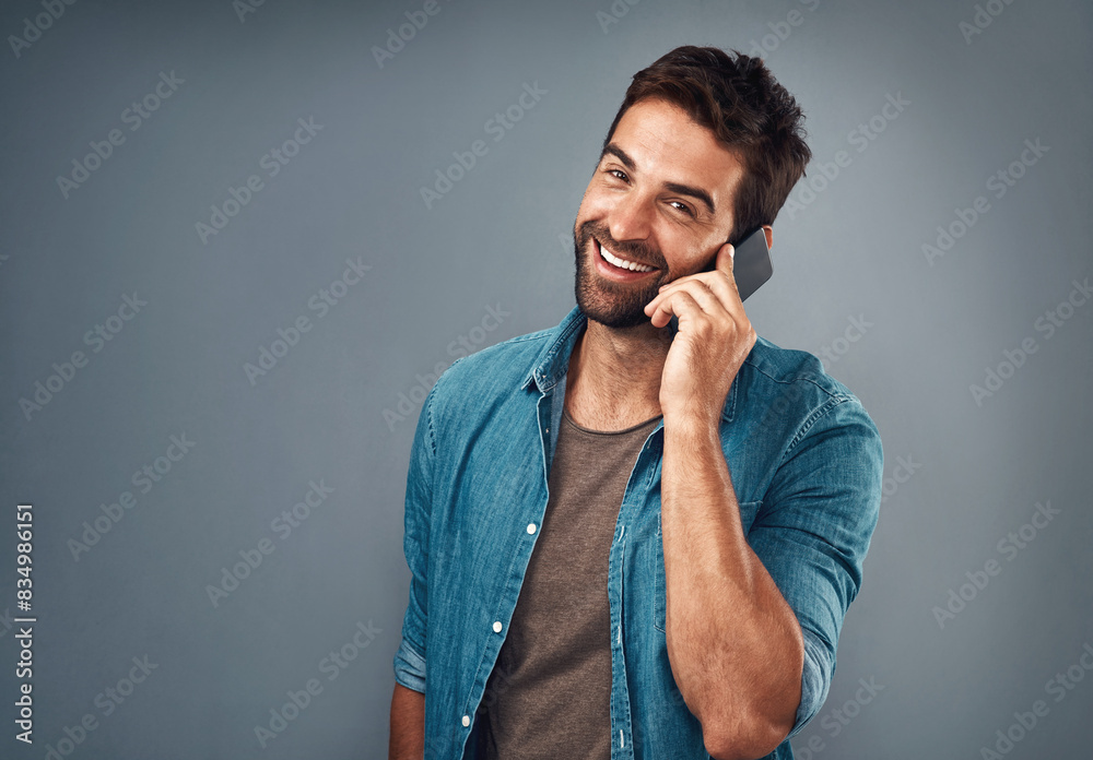 Poster portrait, man and fashion with phone call in studio backdrop for style, cheerful on mobile in gray b