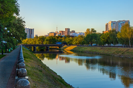 Cityscape with the Lopan River and embankment on a summer evening. Kharkiv city, Ukraine