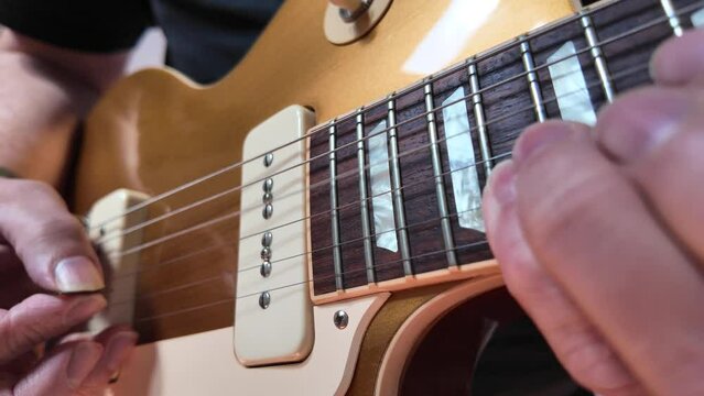 close up footage of musician playing electric guitar