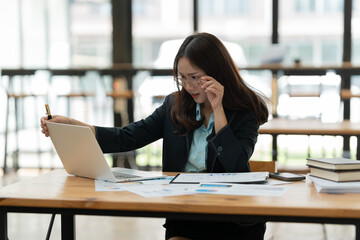 Asian business woman working on a tablet.