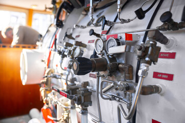 Side view of hyperbaric chamber with valves and pipes