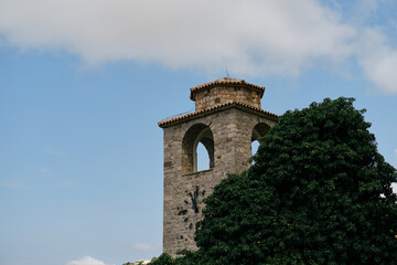 Obraz premium Clock tower within ruins of Old Bar medieval fortress. Montenegro country. A popular tourist destination to visit. Stari Bar - ruined medieval city on Adriatic coast, Unesco World Heritage Site