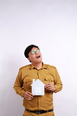 Portrait of Happy thoughtful government worker or pegawai negeri sipil or pns wearing khaki uniform...