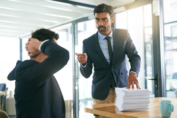 Work, conflict or hr hand pointing at businessman in office with paper, stack or workload, deadline and warning. Corporate, anxiety or manager with intern, stress or threat sign for audit crisis