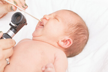 Doctor Examining Newborns Mouth