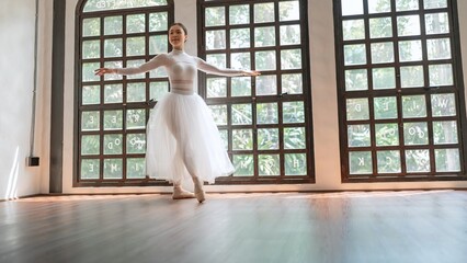 Asian girl ballet dancer creative performance with white skirt demonstrating dancing skill Young...