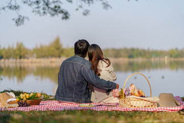 In love couple hugging together enjoying picnic time in park outdoors Picnic. happy couple relaxing...