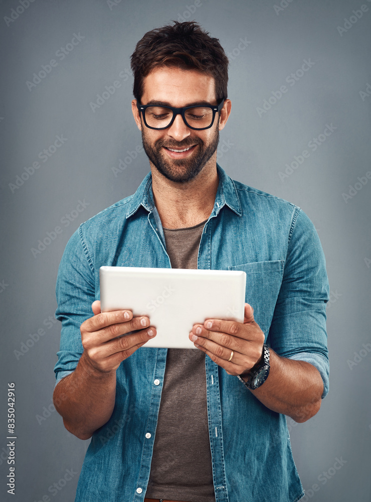 Poster man, studio and reading with tablet and glasses, career with software programming in london. male cr