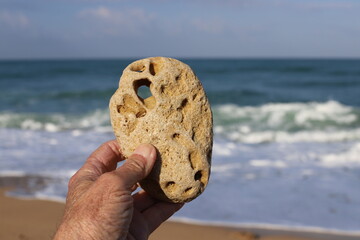 A person's hand holds objects close-up.