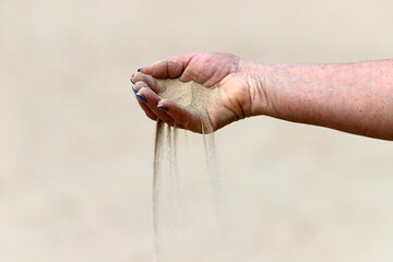 A person's hand holds objects close-up.