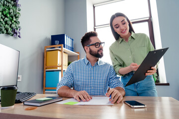 Photo of good mood positive coworkers wear shirts discussing working contracts indoors workplace...