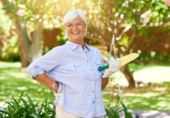 Senior woman, gardening and portrait in home backyard with shovel, smile and plant. Hobby,...