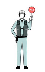 Senior male engineer in helmet and work wear holding a placard with an X indicating incorrect answer.