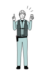 Senior male engineer in helmet and work wear taking security measures for his phone.