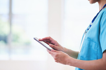 Healthcare Professional Using Digital Tablet in Hospital Setting