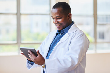 Happy Doctor Using Digital Tablet in Hospital Office