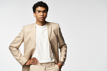 Fototapeta premium African American man in stylish sunglasses posing confidently in a tan suit.