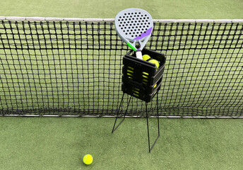 Background of padel racket and ball on artificial grass floor in outdoor court. Top view.