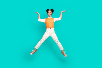 Full size photo of nice young girl jump hold empty space wear vest isolated on teal color background