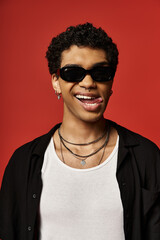 Handsome African American man wearing sunglasses and a black shirt.