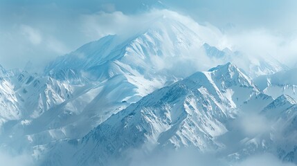 Obraz premium Snow-covered mountains with misty peaks, capturing the serene beauty of winter landscapes and the majestic calmness of high altitudes.