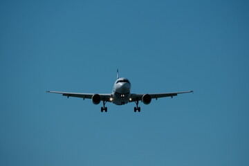 Airplane landing at the airport on a sunny day