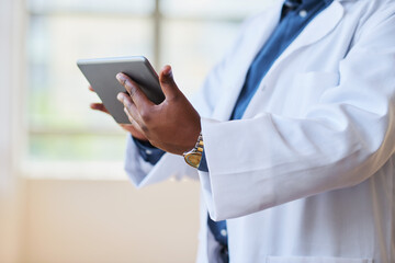 Healthcare Professional Using Tablet in Modern Hospital Setting for Patient Management