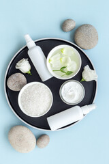 Set of cosmetic products on tray on the bathroom table