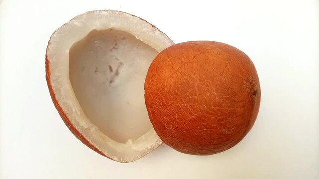 Coconut half pieces rotating on a white background. Coconut top view closeup. Healthy food