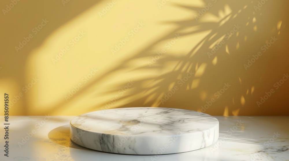Aufkleber a round marble stand is placed on a sleek white surface against a yellow wall with shadows of leaves