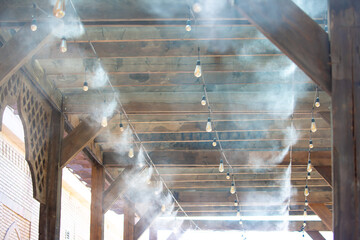 Water spray system for cooling the terrace on a hot summer day. Fogging system, high pressure water...