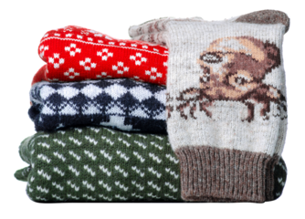 Stack folded knitted sweaters, socks Christmas on white background isolation