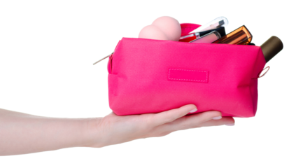 Pink cosmetic bag with many make up cosmetics beauty in hand on white background isolation