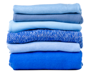 Stack folded blue sweaters on white background isolation