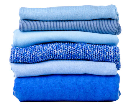 Stack folded blue sweaters on white background isolation