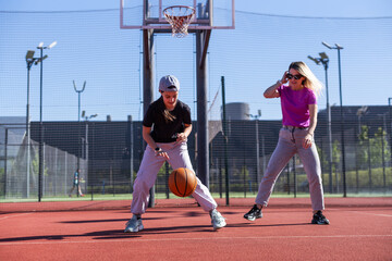 Mother and daughter playing basketball.