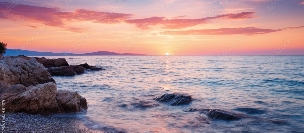 Poster Sunset over the sea with a tranquil tide and a beautiful view in the background with copy space image.