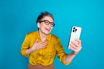 Photo of funny attractive lady dressed shirt glasses talking modern gadget laughing isolated blue...