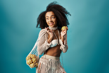 Stylish woman with curly hairstyle holding bag of apples.