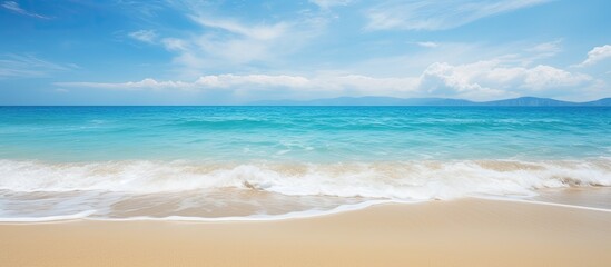 Gorgeous beach with golden sand where the waves gently roll in, perfect for a relaxing day with a copy space image.