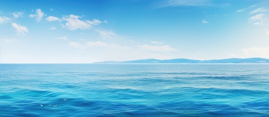 Obraz premium Tranquil blue sea surface banner with copy space image.