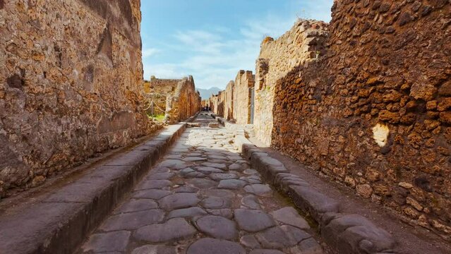 Via Stabiana, with its famous stepping stones and chariot ruts in Pompeii, Naples, Campania, Italy, an ancient Roman city buried by Mount Vesuvius in 79 AD